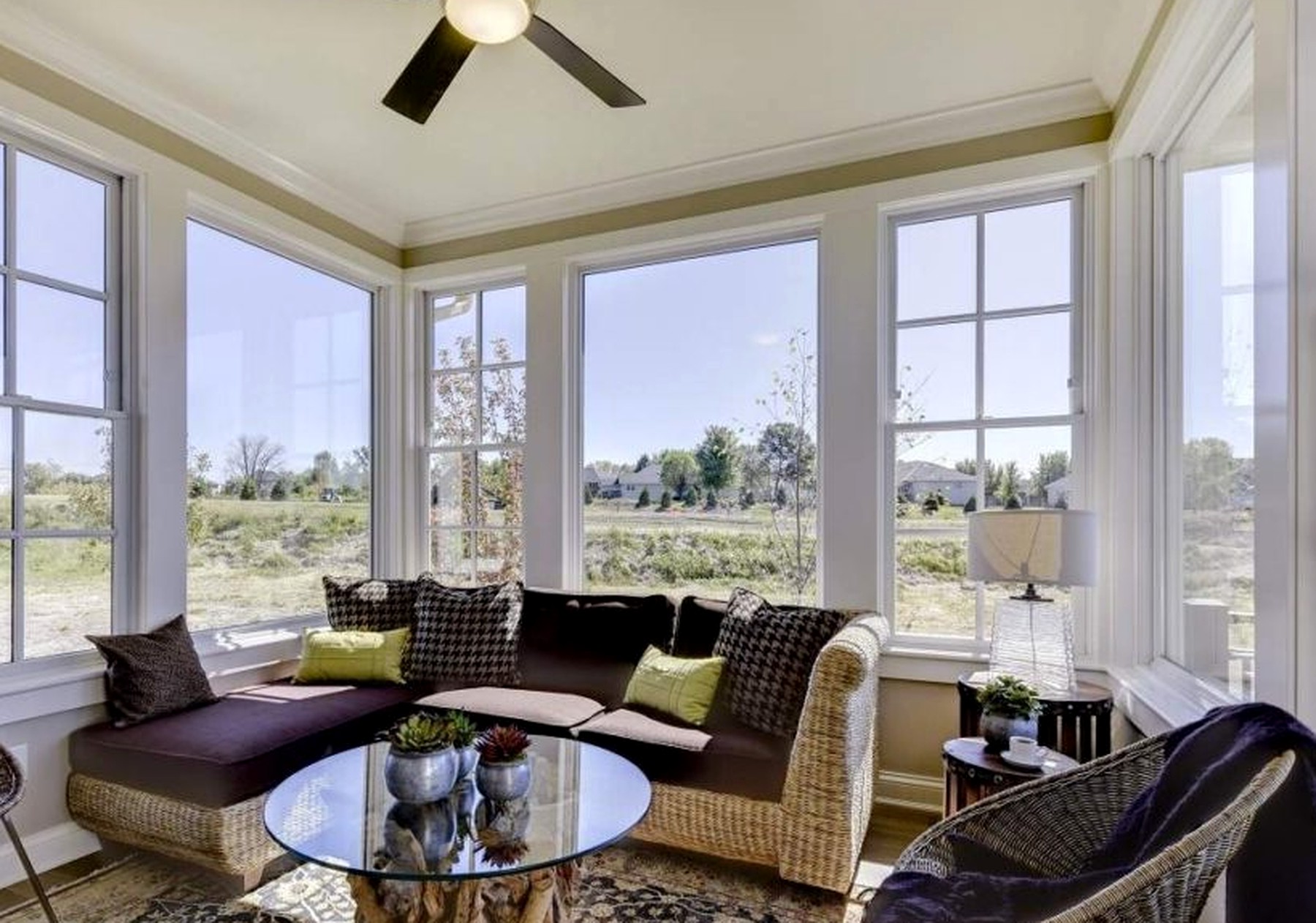 Four-season porch wrapped in windows, looking out over open prairie