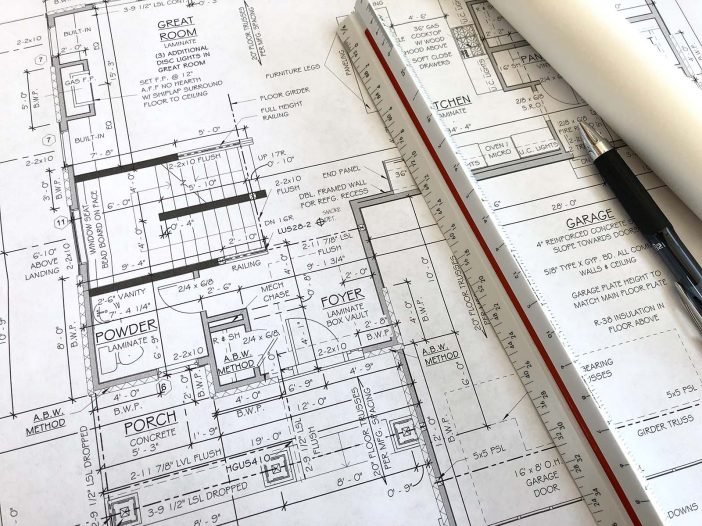 Working drawings and plan sheets laid out on a table