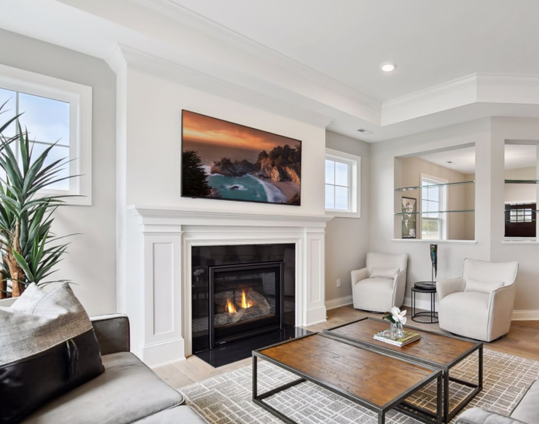 Great room of The Orchard Villa with a stone fireplace and lake view