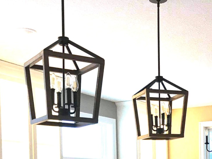 Blackened lantern pendants over a LEVEL 310 kitchen island